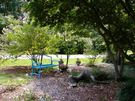 Blue bench in front garden
